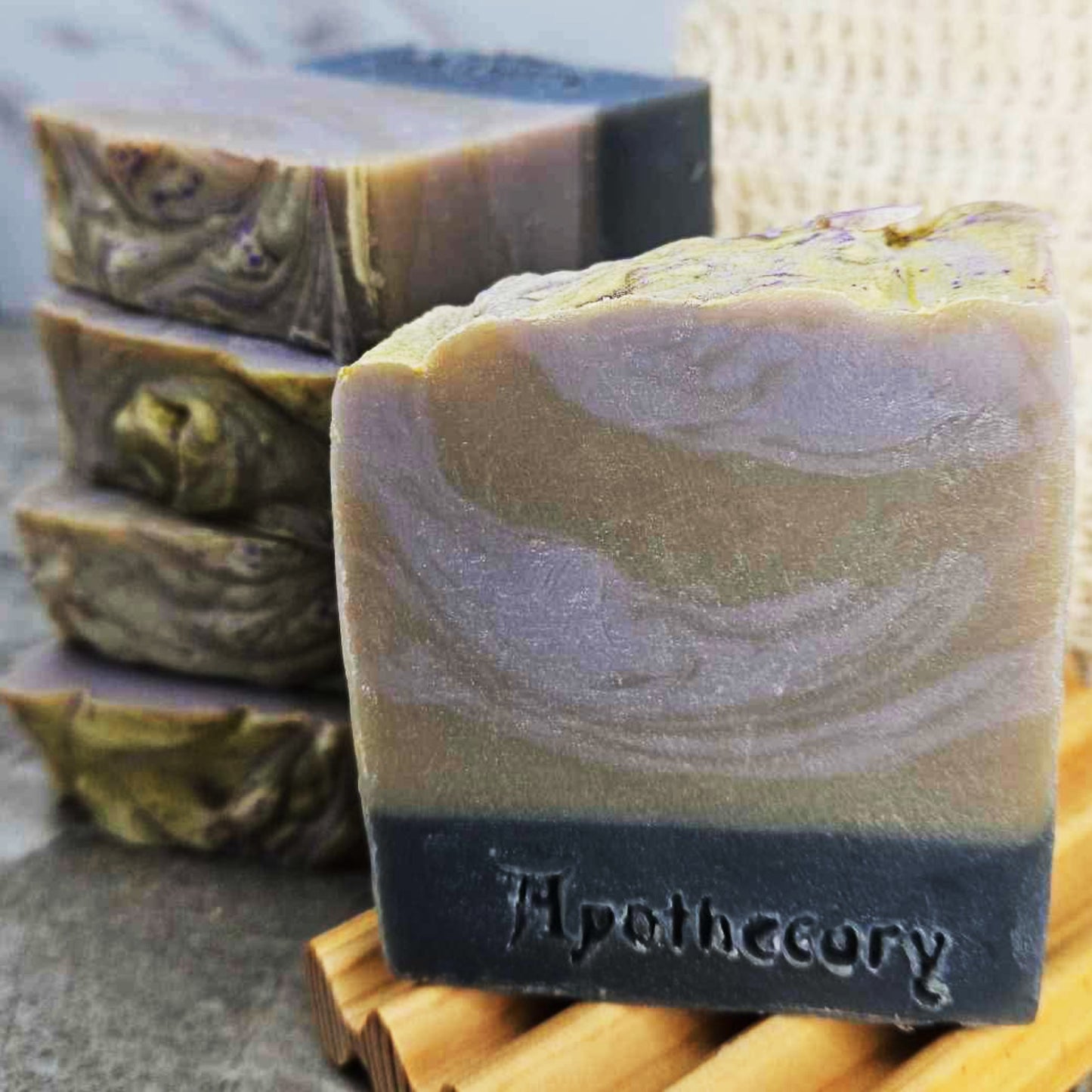 Black, grey, and purple swirled soap scented with lavender and leather